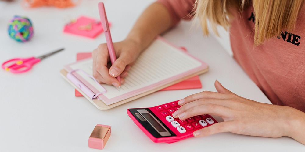 Student working on math with a calculator and a notebook