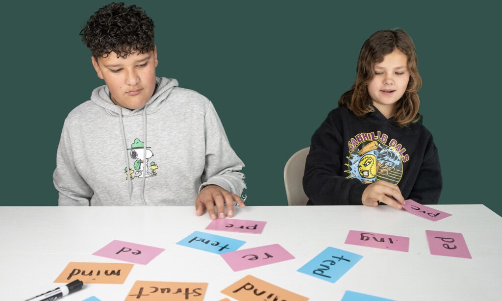 Students working with word cards at a table