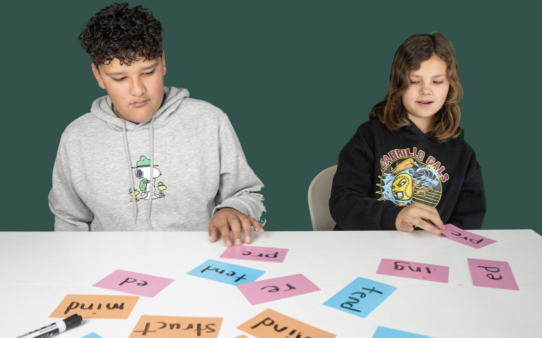 Students working with word cards at a table